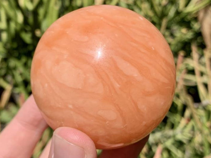Polished Orange Twist Calcite Sphere x 1 From Madagascar